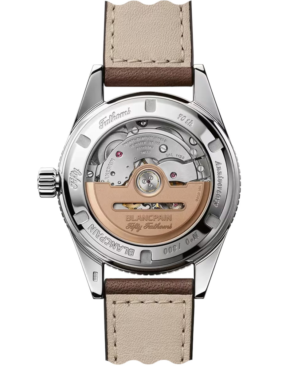 Transparent case back of a Blancpain Fifty Fathoms watch, revealing the mechanical movement and rose-gold rotor with a beige leather strap