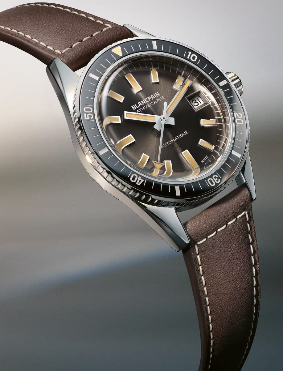 Blancpain stainless steel wristwatch with a brown leather strap, meteor grey dial, and rotating bezel featuring date window at 3 o'clock