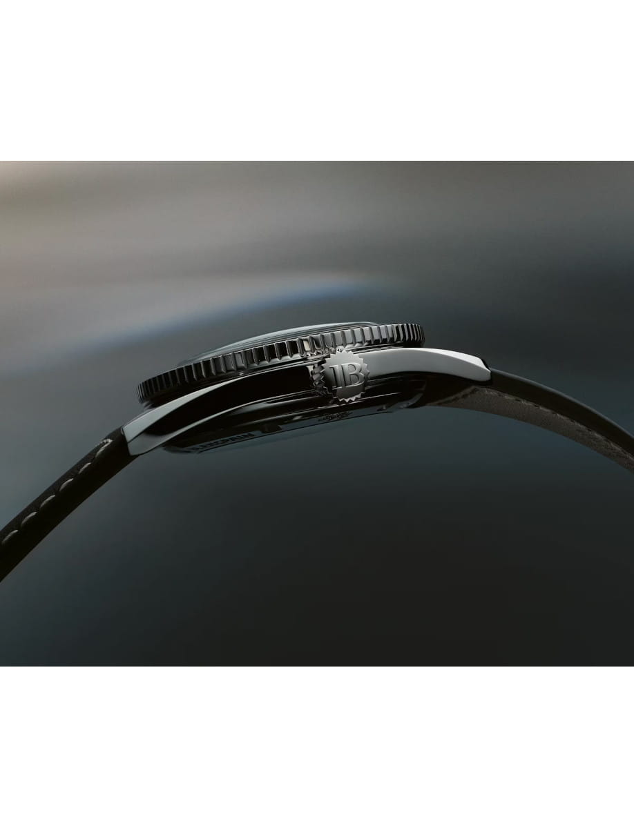 Close-up of a Blancpain stainless steel wristwatch with brown leather strap, meteor grey dial.