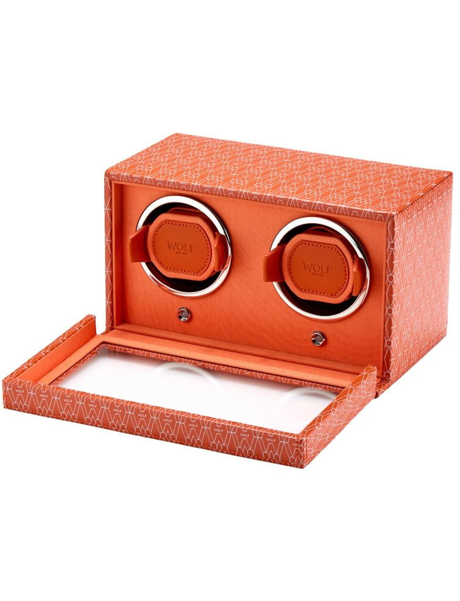 Orange over-ear headphones in a matching orange gift box, open to display the product surface labels.