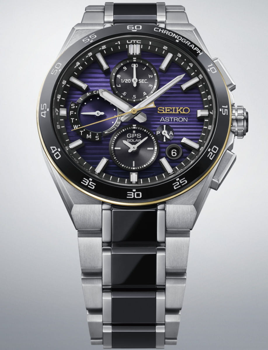 Seiko Astron titanium chronograph wristwatch with purple striped dial, multiple subdials, and a silver/black titanium bracelet.