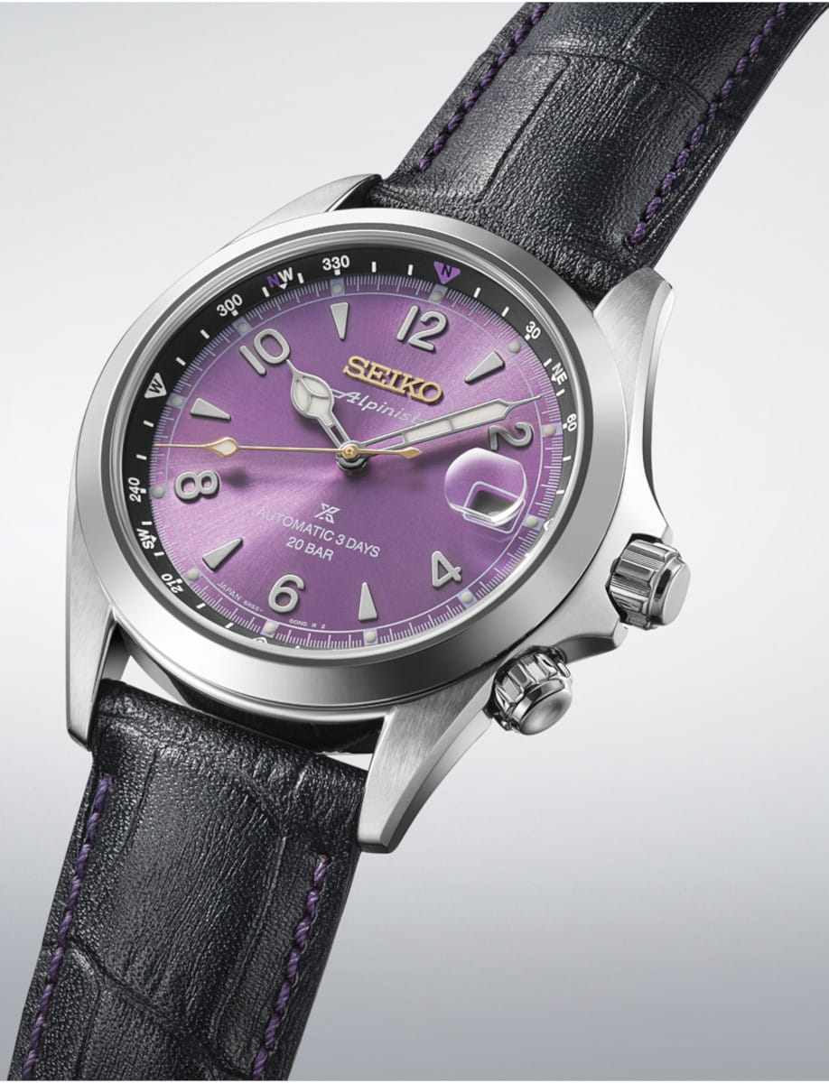 Purple-dial Seiko wristwatch with black leather strap and purple stitching, angled to show dial and crown details, stylish and premium.