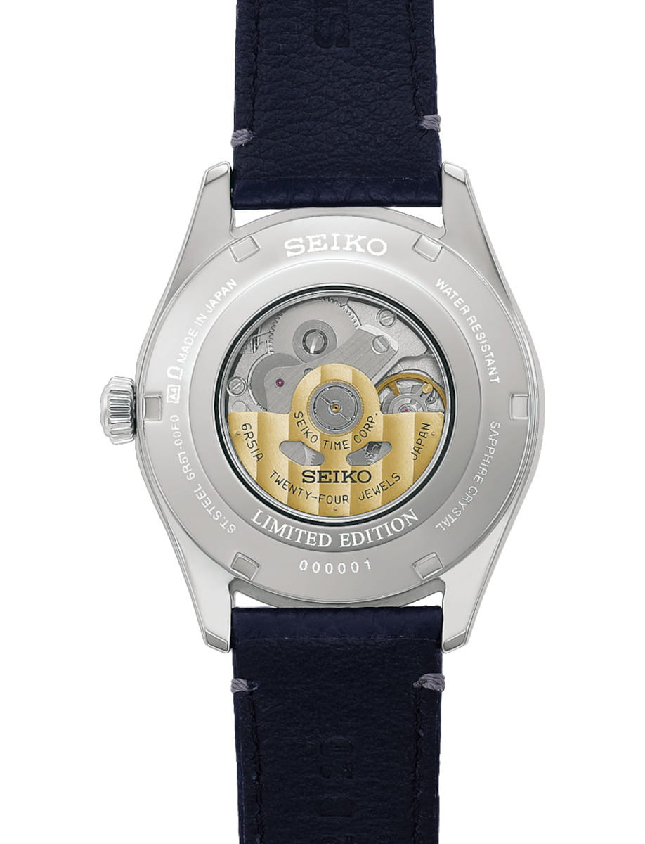 Back view of a Seiko limited-edition wristwatch with a transparent case back showing the mechanical movement; stainless steel case, gold-toned rotor, and a cow leather strap. Serial number 000001 visible.