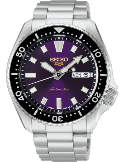 Seiko automatic diver-style wristwatch with a purple dial, black bezel, and stainless steel bracelet displaying day and date.