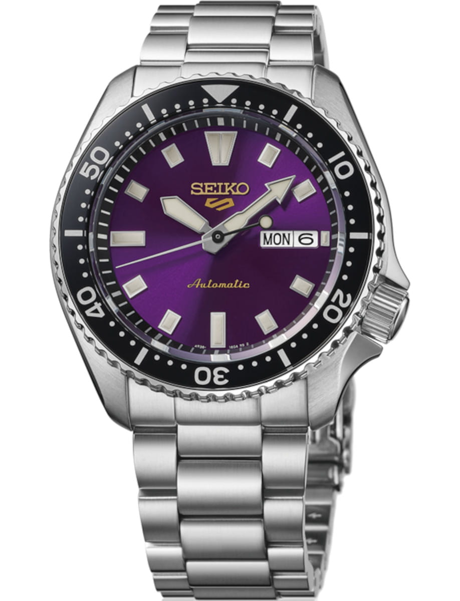 Seiko automatic dive watch with a purple dial and stainless steel bracelet, showing day/date window.