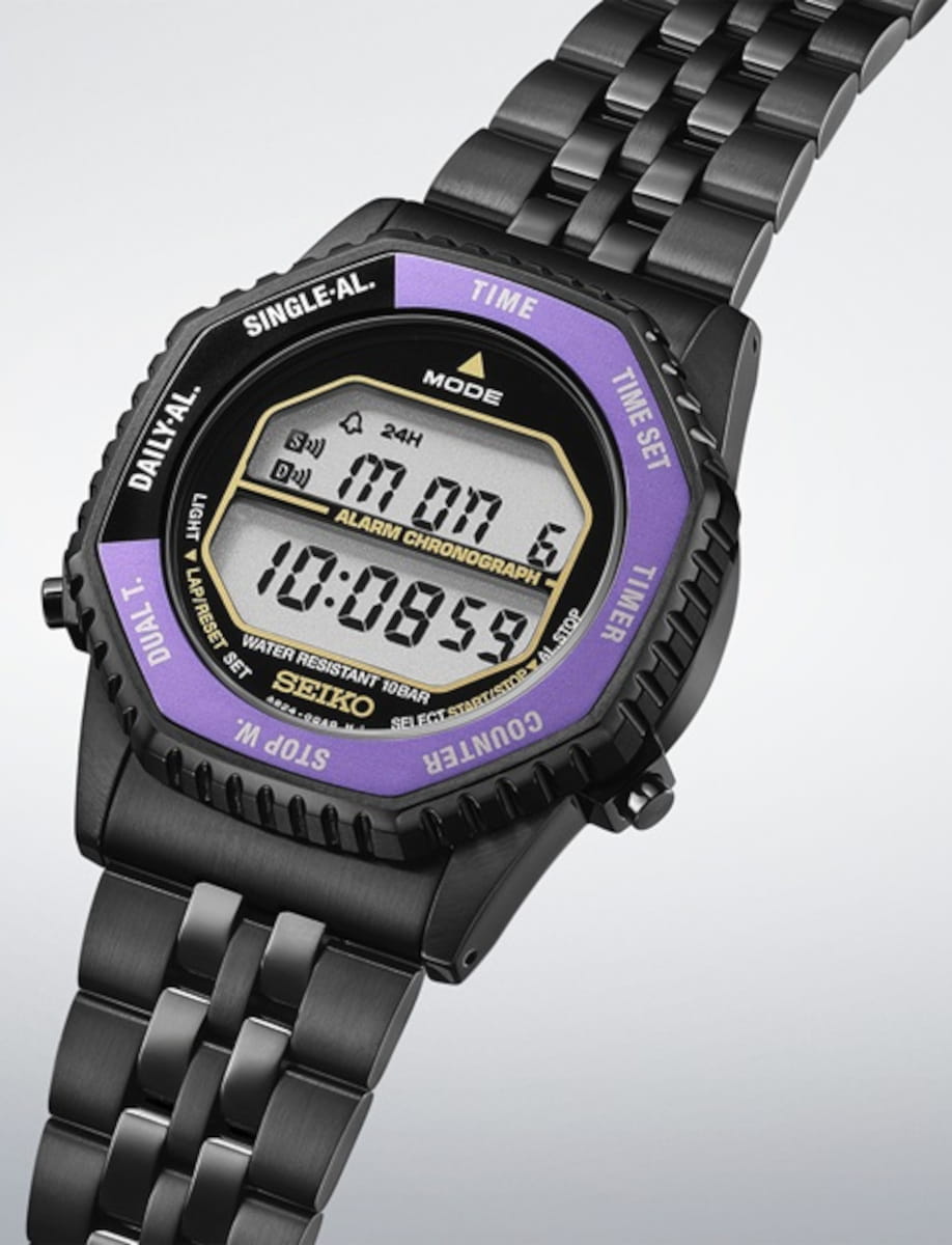 Seiko black digital sports watch with a purple bezel and metal link bracelet, displaying time on an LCD screen.
