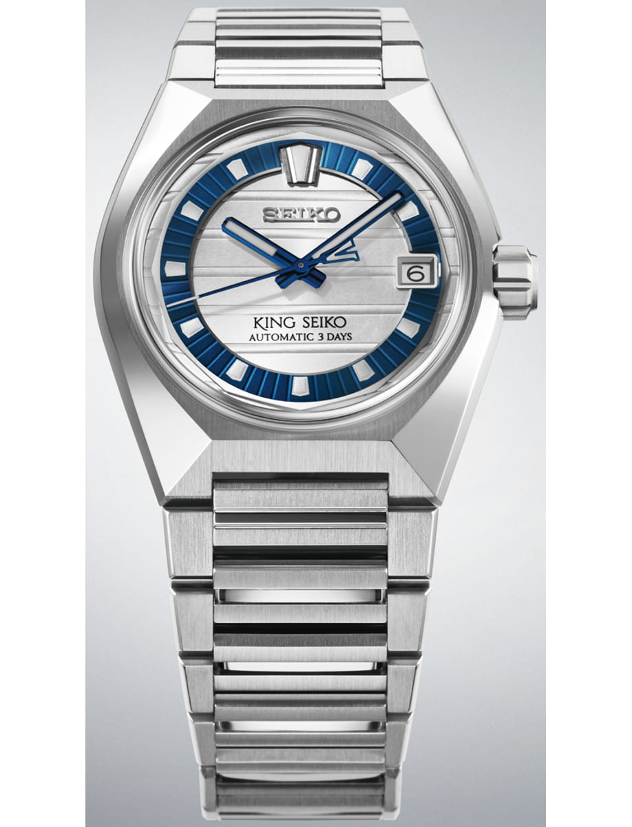 Stainless steel King Seiko automatic watch with a blue-ringed dial and date window at 3 o'clock, on a matching metal bracelet.