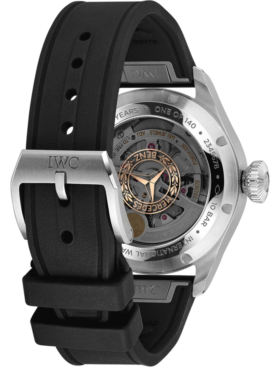 IWC wristwatch with a see-through case back showing the mechanical movement and rotor, black rubber strap