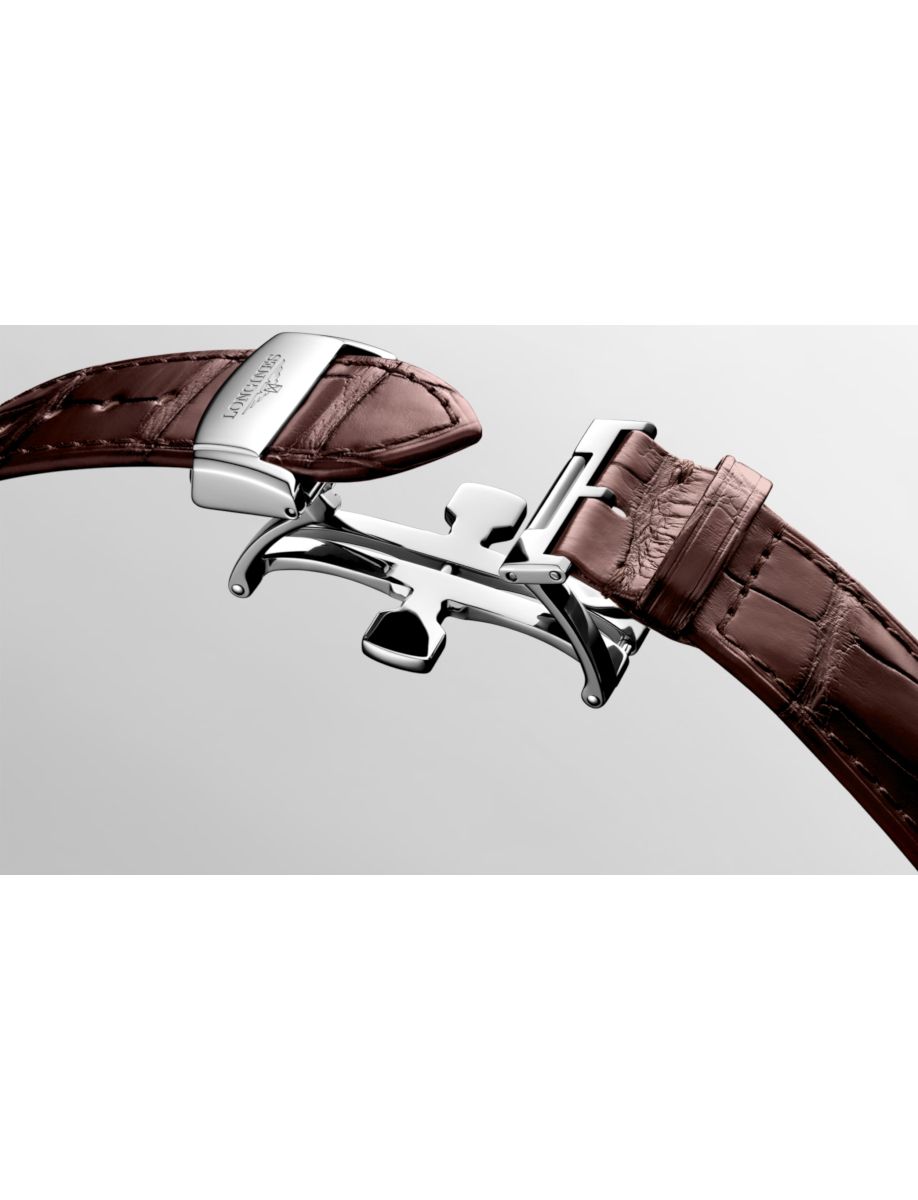 Close-up of a silver deployment watch clasp connecting a brown leather strap against a neutral gray background.