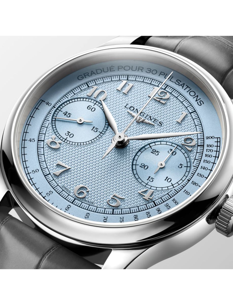 Close-up of a blue dial Longines wristwatch with silver case and two subdials.