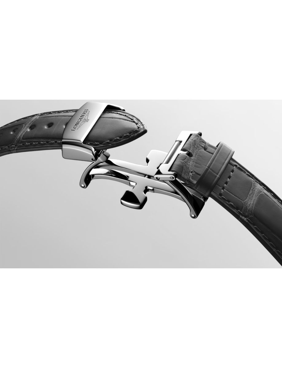 Close-up of a metal deployment clasp on a black leather watch strap labeled Longines, showing the folding mechanism.