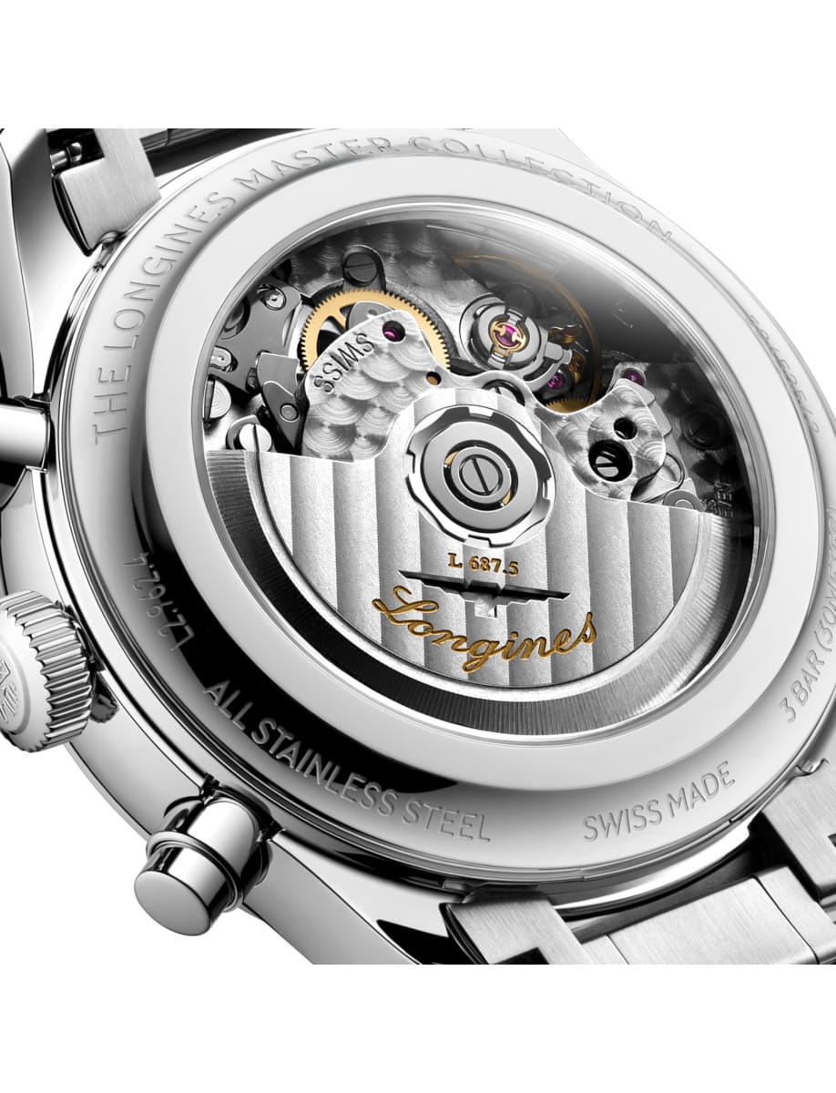 Exposed watch movement with mechanical gears visible through a transparent caseback, Longines engraved wording and polished stainless steel bracelet nearby