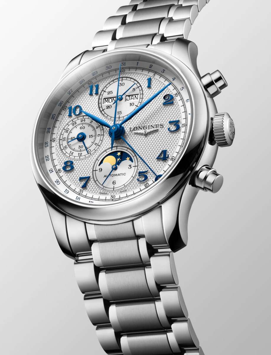 Stainless steel wristwatch with blue hands, multiple subdials, and a moon phase display, branded Longines.