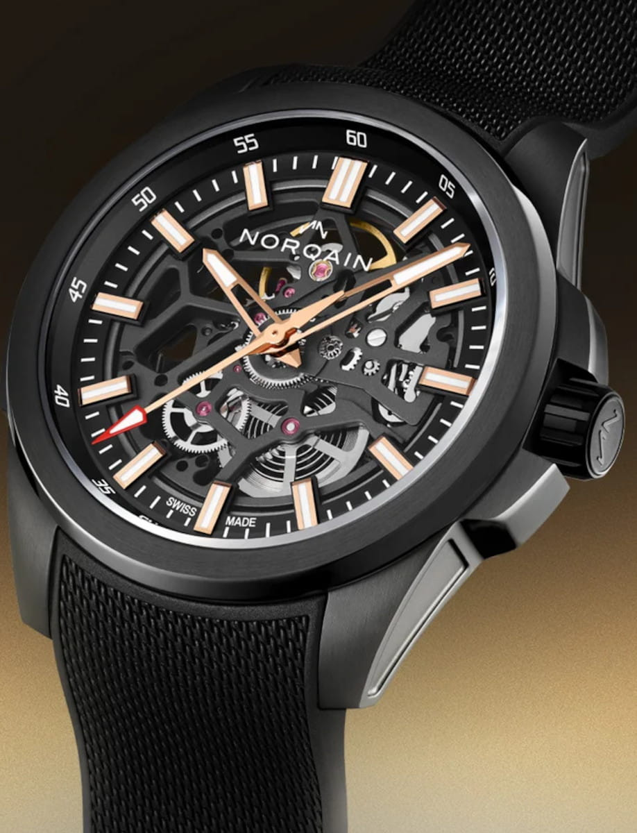 Skeleton wristwatch with black case, rose-gold hands and hour markers, and visible gears on a black strap.