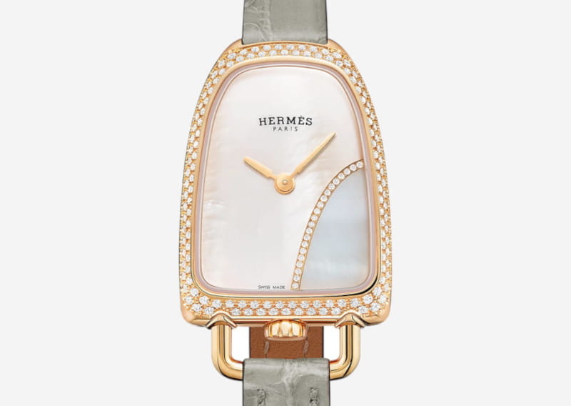 Hermès Paris women's wristwatch with a diamond-studded bezel, rose-gold case, mother-of-pearl dial, and gray strap