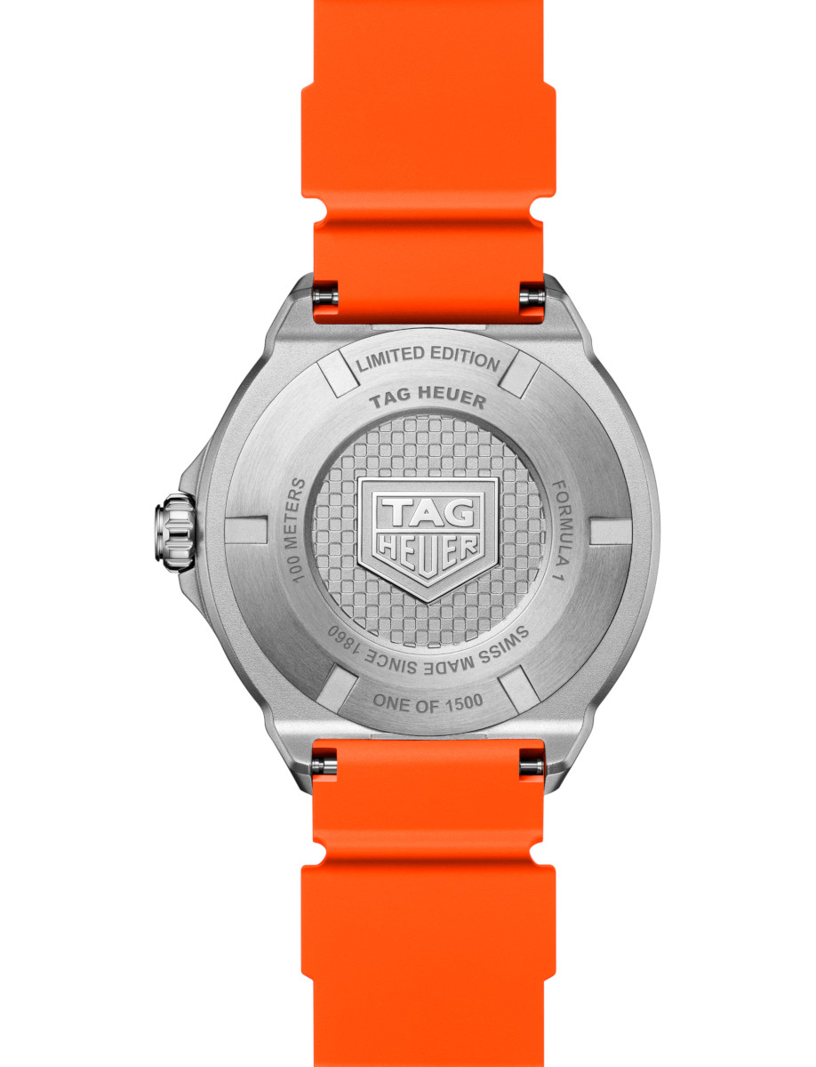 Back of a stainless steel Tag Heuer watch with an orange strap; engravings include 'Limited Edition', 'Swiss Made', and the TAG Heuer shield.