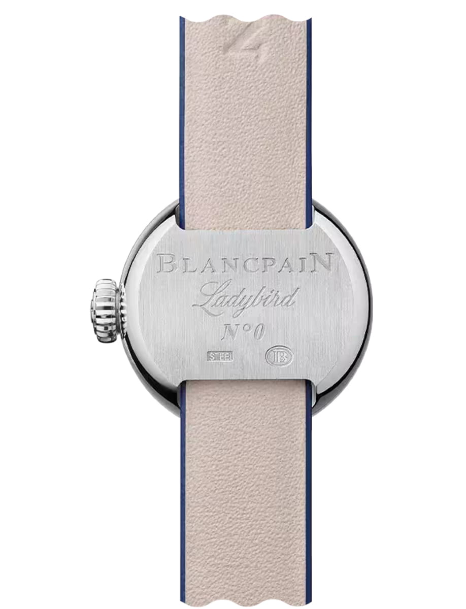 Back of a Blancpain Ladybird wristwatch with engraved branding and a beige leather strap with blue edges, crown on the left.
