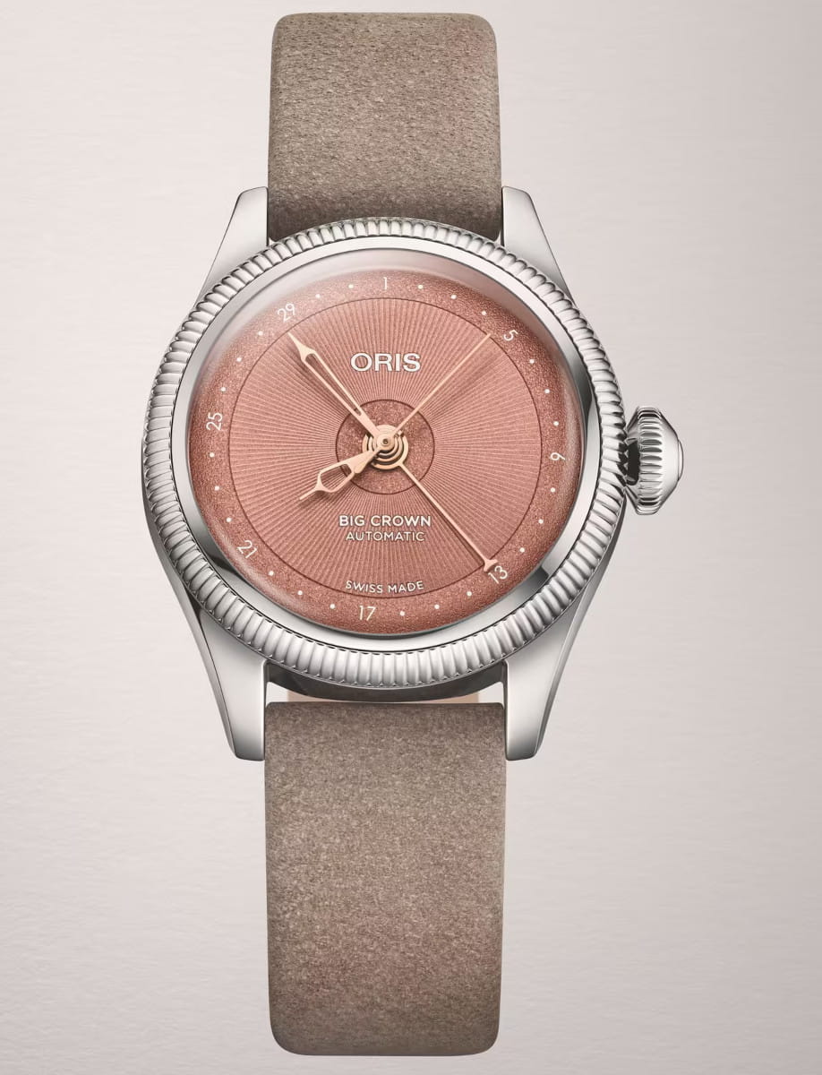 Close-up of an Oris Big Crown automatic wristwatch with stainless steel case, a pink dial and brown leather strap.