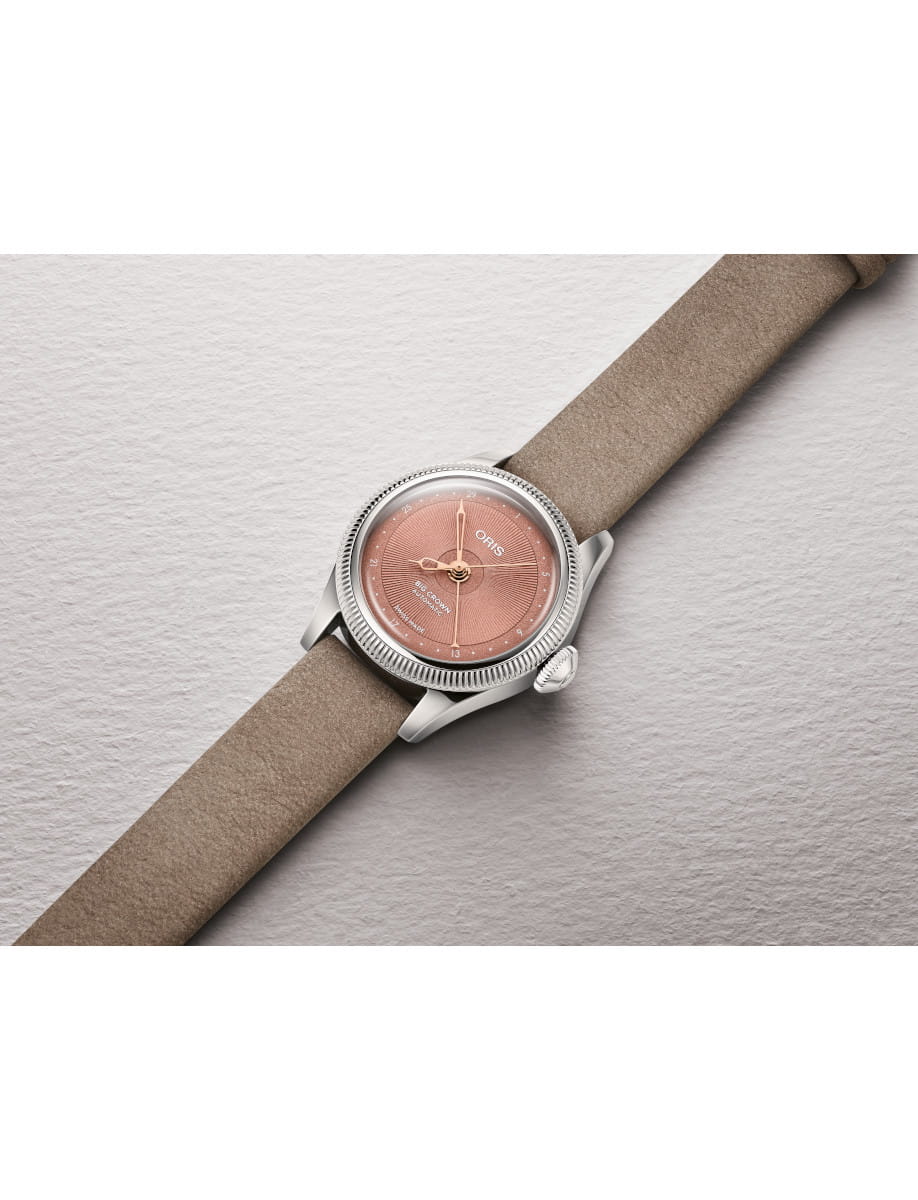 Side view of Oris Big Crown automatic wristwatch with stainless steel case, a pink dial and brown leather strap.