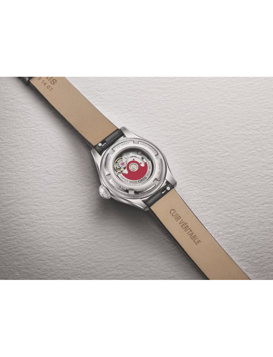 Wristwatch with a transparent case back exposing its mechanical movement and a beige leather strap.