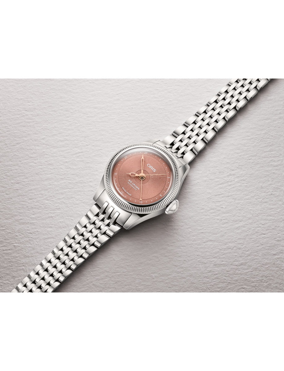 Side view of Oris Big Crown automatic wristwatch with a pink textured dial and stainless steel link bracelet