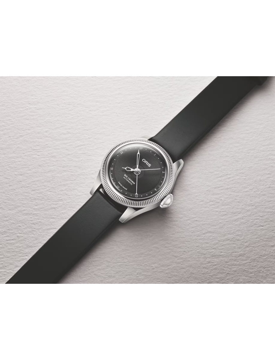 Side view of Oris Big Crown automatic wristwatch with a black grained dial, stainless steel case, and black leather strap.