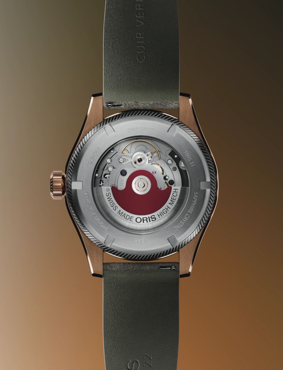 Oris Swiss-made high-mech automatic watch with an open case back showing the movement and rotor; bronze case, green strap.