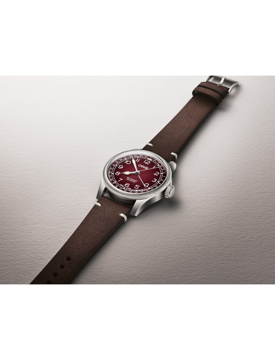 Side view of Oris Big Crown Automatic wristwatch with burgundy dial, luminous numerals, and Brown Cervo Volante sustainable deer leather strap.