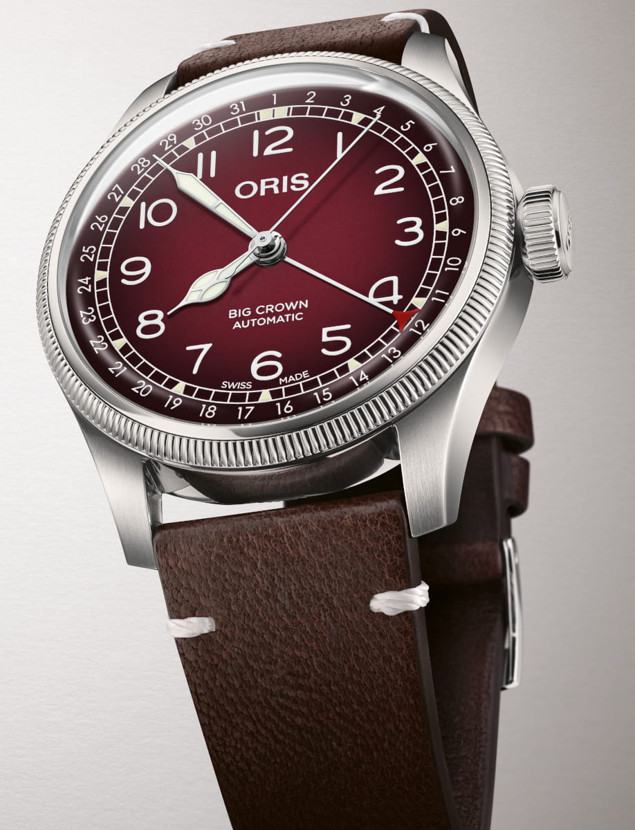 Close up view of Side view of Oris Big Crown Automatic wristwatch with burgundy dial, luminous numerals, and Brown Cervo Volante sustainable deer leather strap.