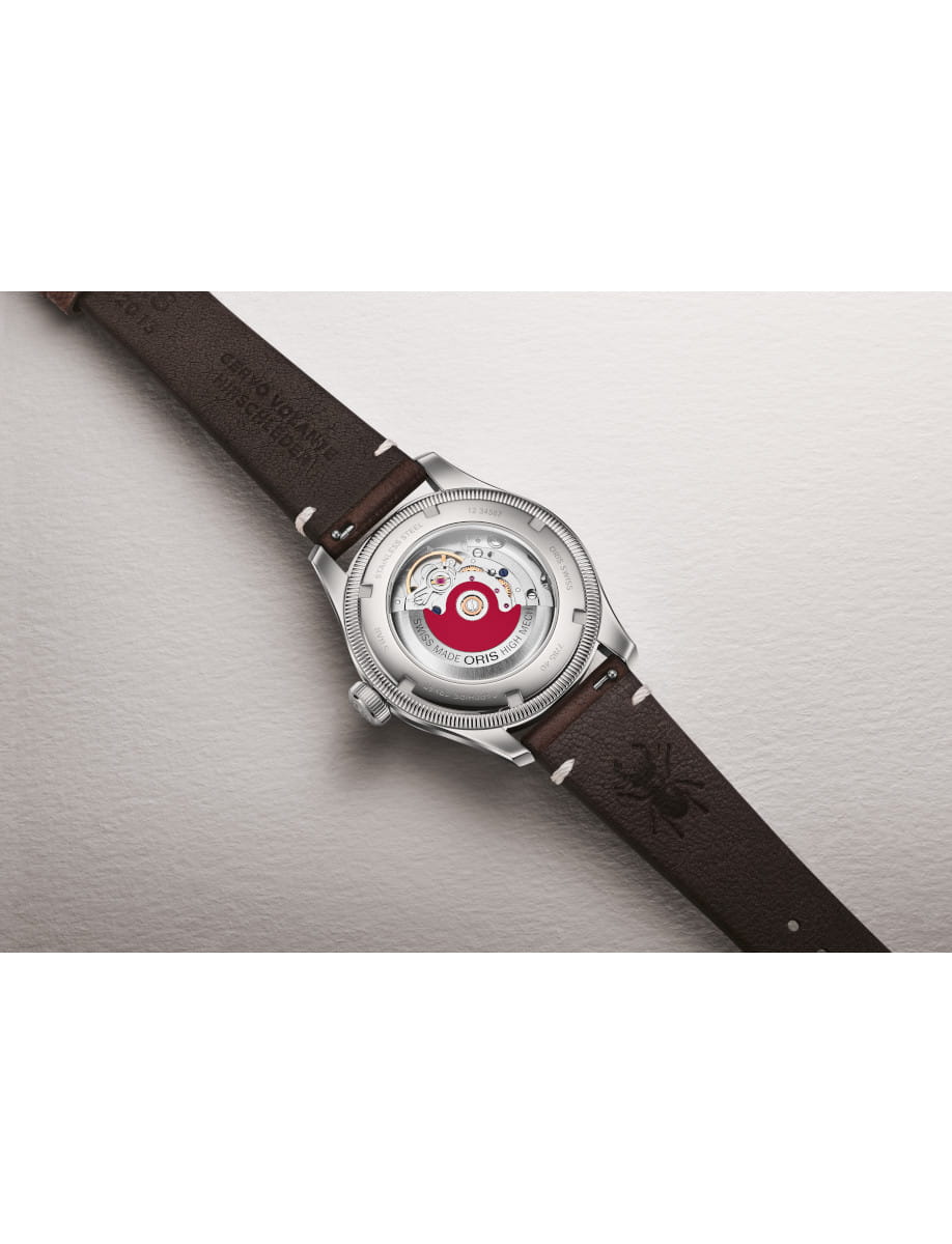 Close-up of Oris wristwatch showing its transparent case back and exposed movement, with a brown leather strap.