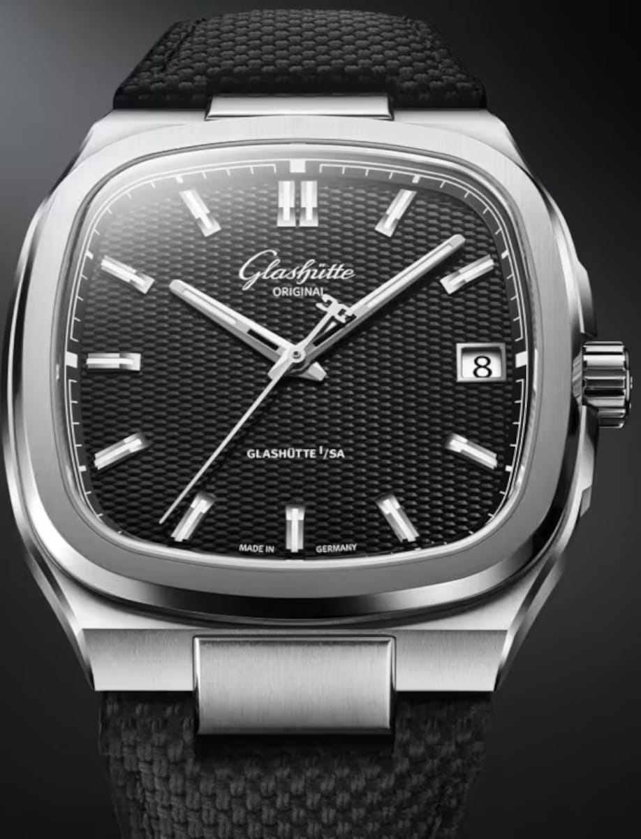 Close-up of a Glashütte Original watch with a black galvanized dial, date at 3, on a black rubber strap.