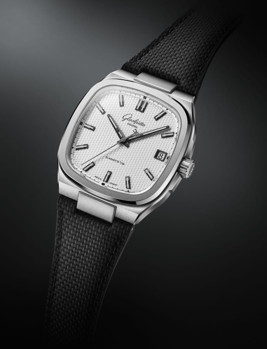 Side view of Glasshute Original stainless steel wristwatch with a silvern galvanized dial, stainless steel case, and black rubber strap.