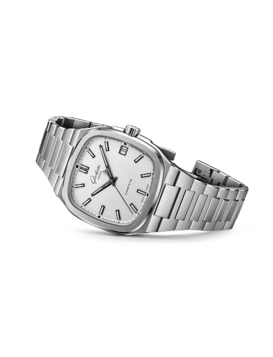 Stainless steel wristwatch with a galvanizied silvern dial and a date window, shown at a slight angle.