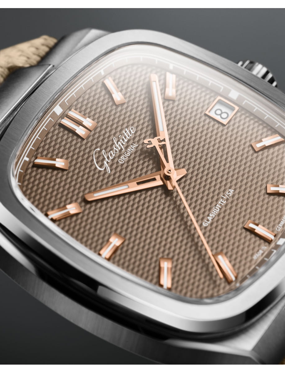 Close-up of a Glashütte Original wristwatch with a brown galvanized dial, and a date window at 3 o'clock.
