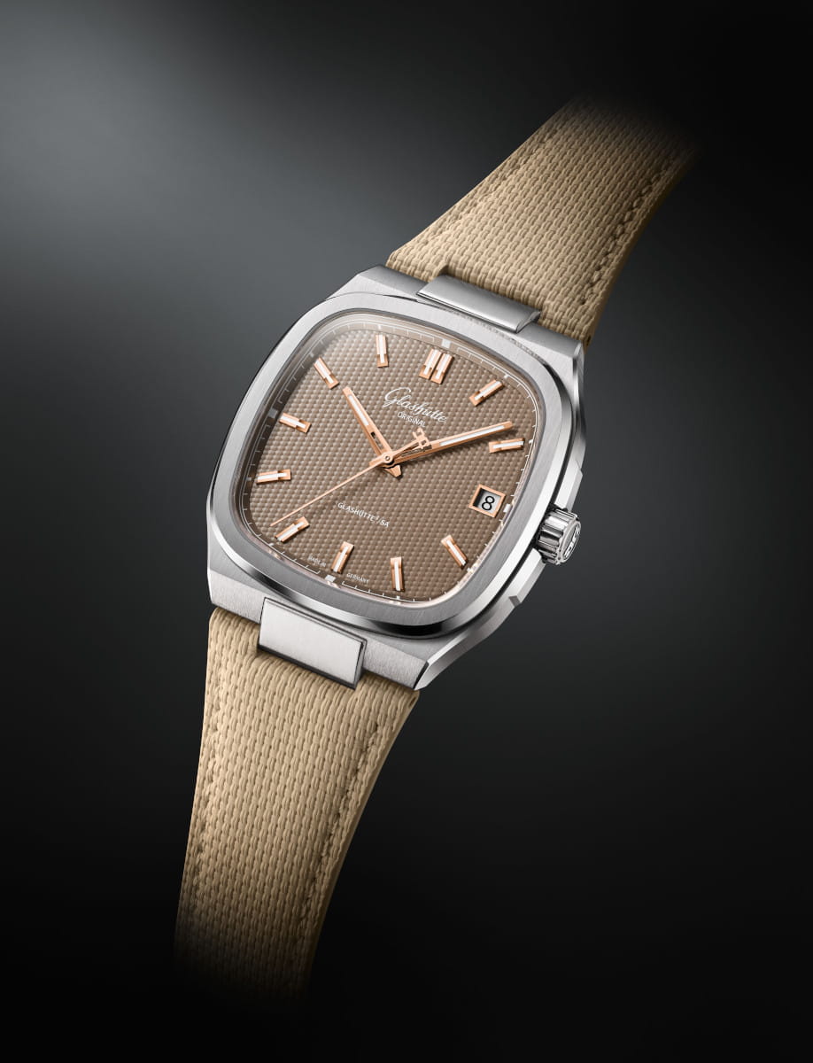 Side view of Glashütte watch with stainless steel case, beige rubber strap, brown galvanized dial, date window at 3 o'clock.