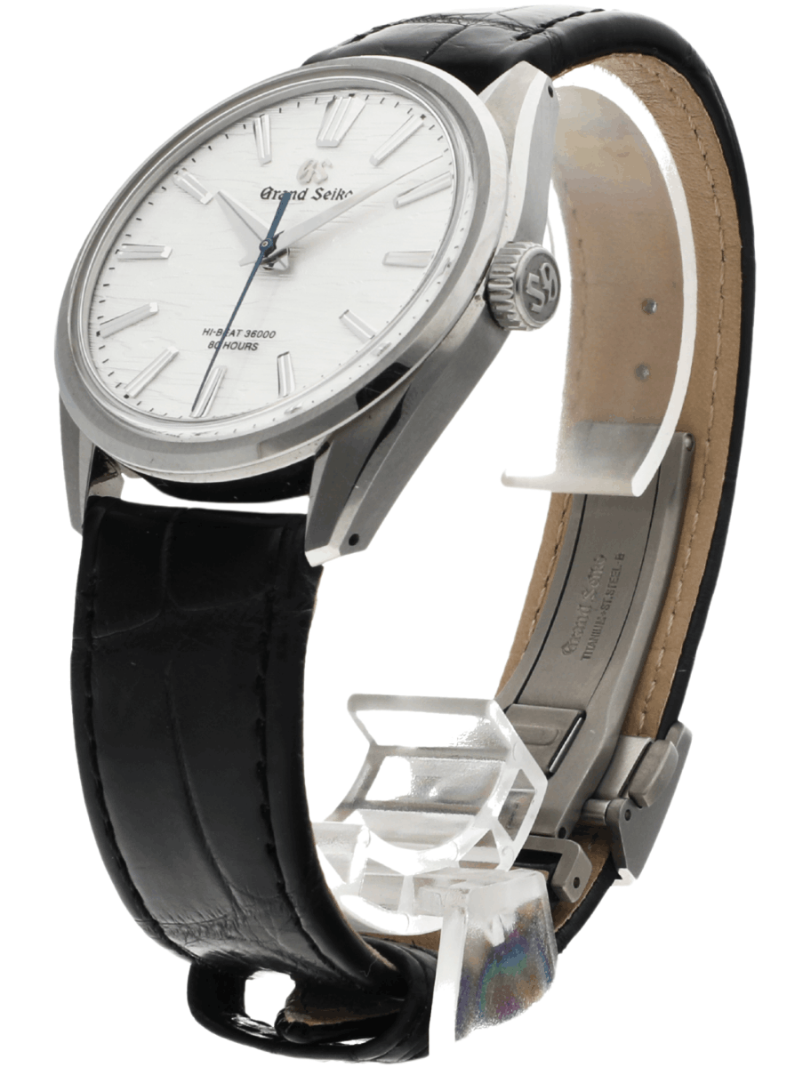 Side view of pre-owned Grand Seiko wristwatch with a stainless steel round case, white dial, and a black leather strap.