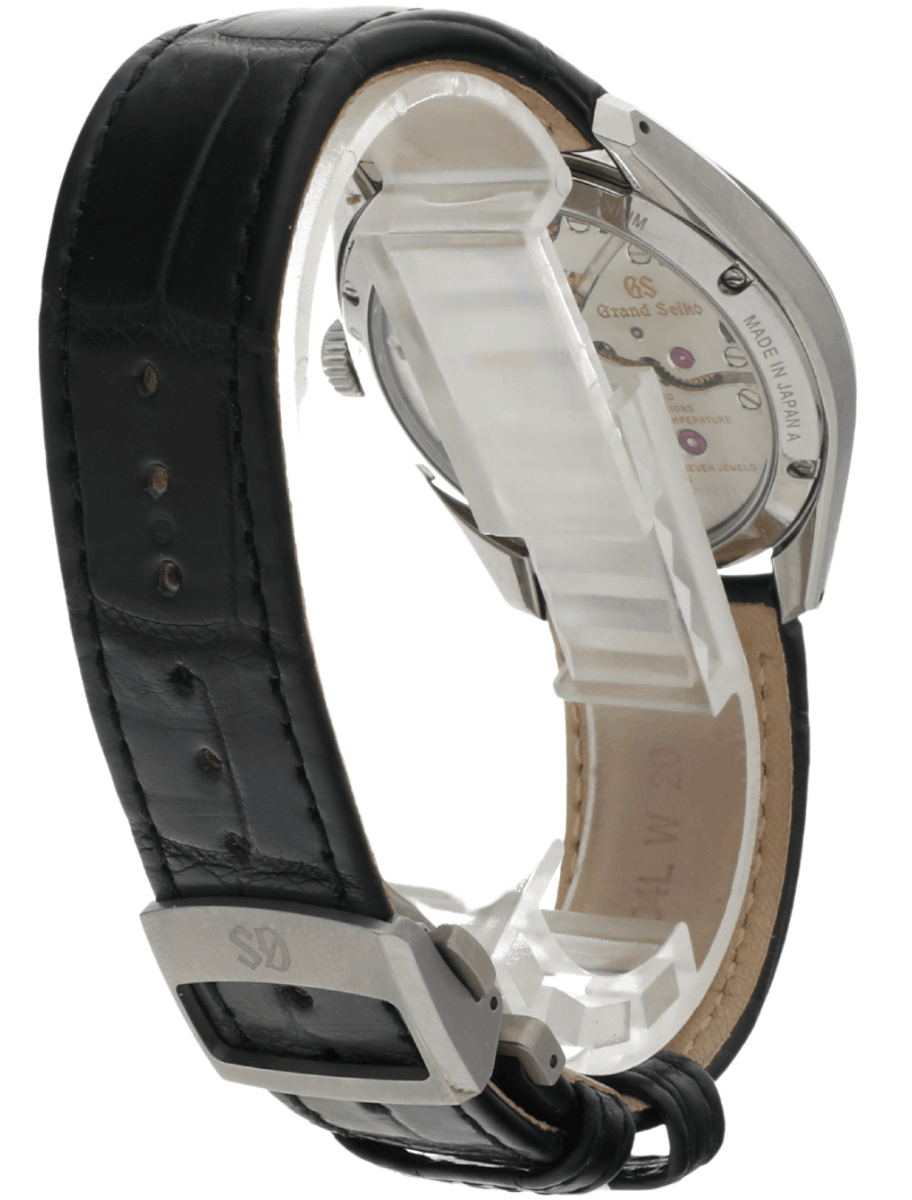 Back view of pre-owned Grand Seiko wristwatch with a stainless steel round case, transparent case back, and a black leather strap.