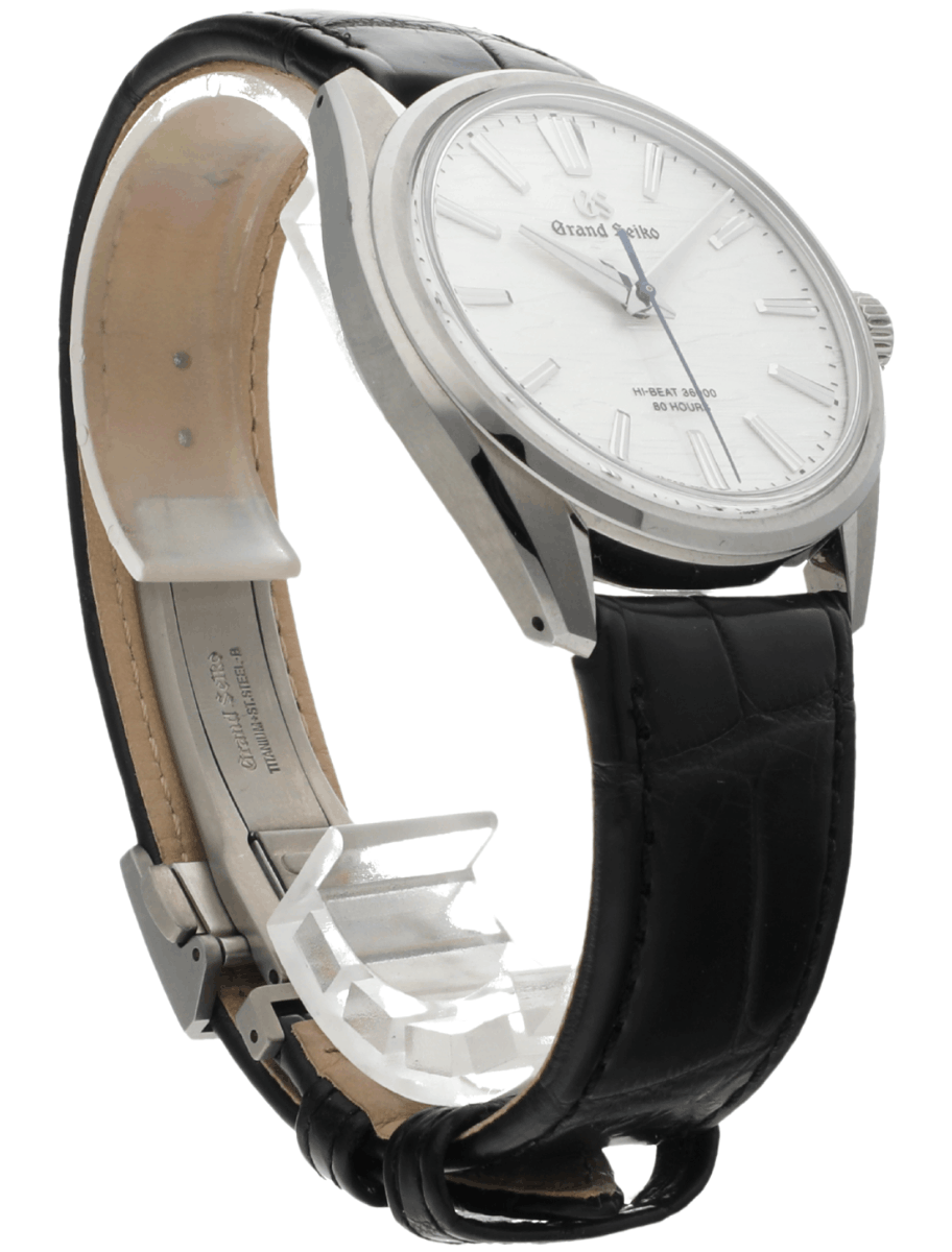 Side view of pre-owned Grand Seiko wristwatch with a stainless steel round case, white dial, and a black leather strap.