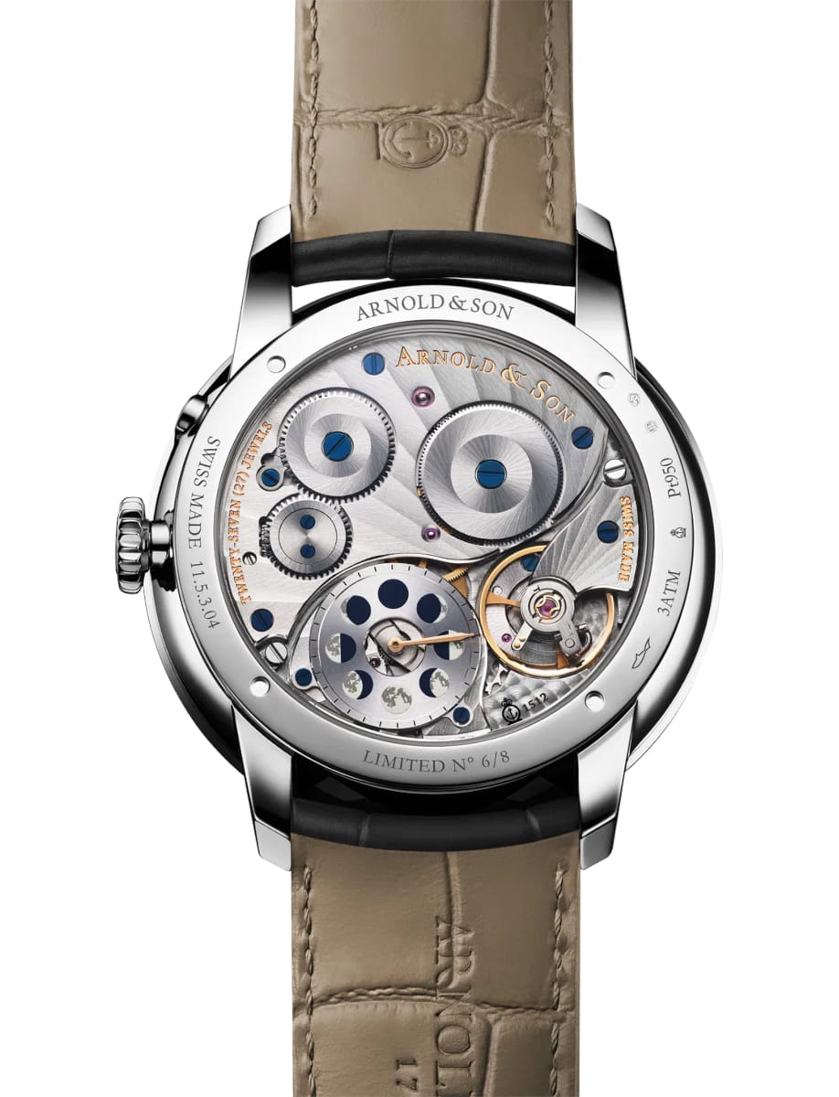 Back view of an Arnold & Son mechanical wristwatch with a transparent case back revealing gears and blue screws, beige leather strap visible at top and bottom.
