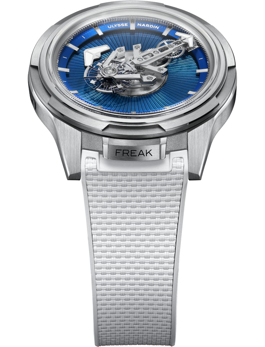 Front view of Ulysse Nardin wristwatch with titanium case, no dial, no hands, no crown, and white rubber strap.
