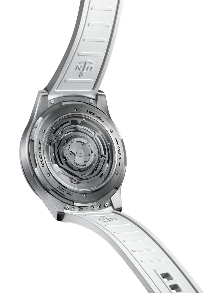 Back view of a titanium luxury wristwatch with an exposed mechanical movement, marked Limited Edition and Swiss Made, on a white rubber strap.