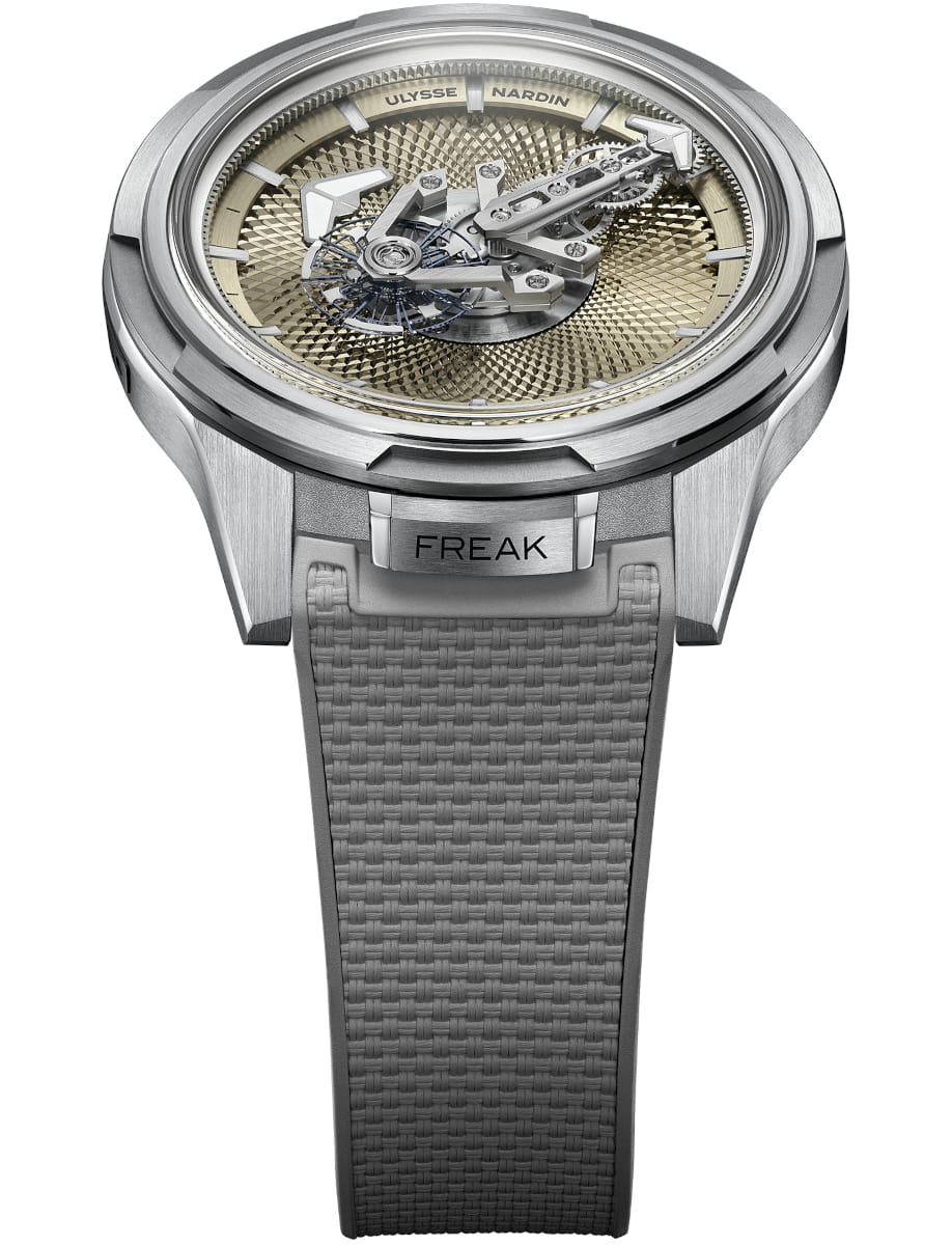 Front view of Ulysse Nardin wristwatch with titanium case, no dial, no hands, no crown, and grey rubber strap.