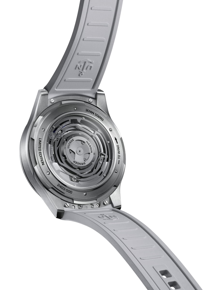Back view of a titanium luxury wristwatch with an exposed mechanical movement, marked Limited Edition and Swiss Made, on a grey rubber strap.