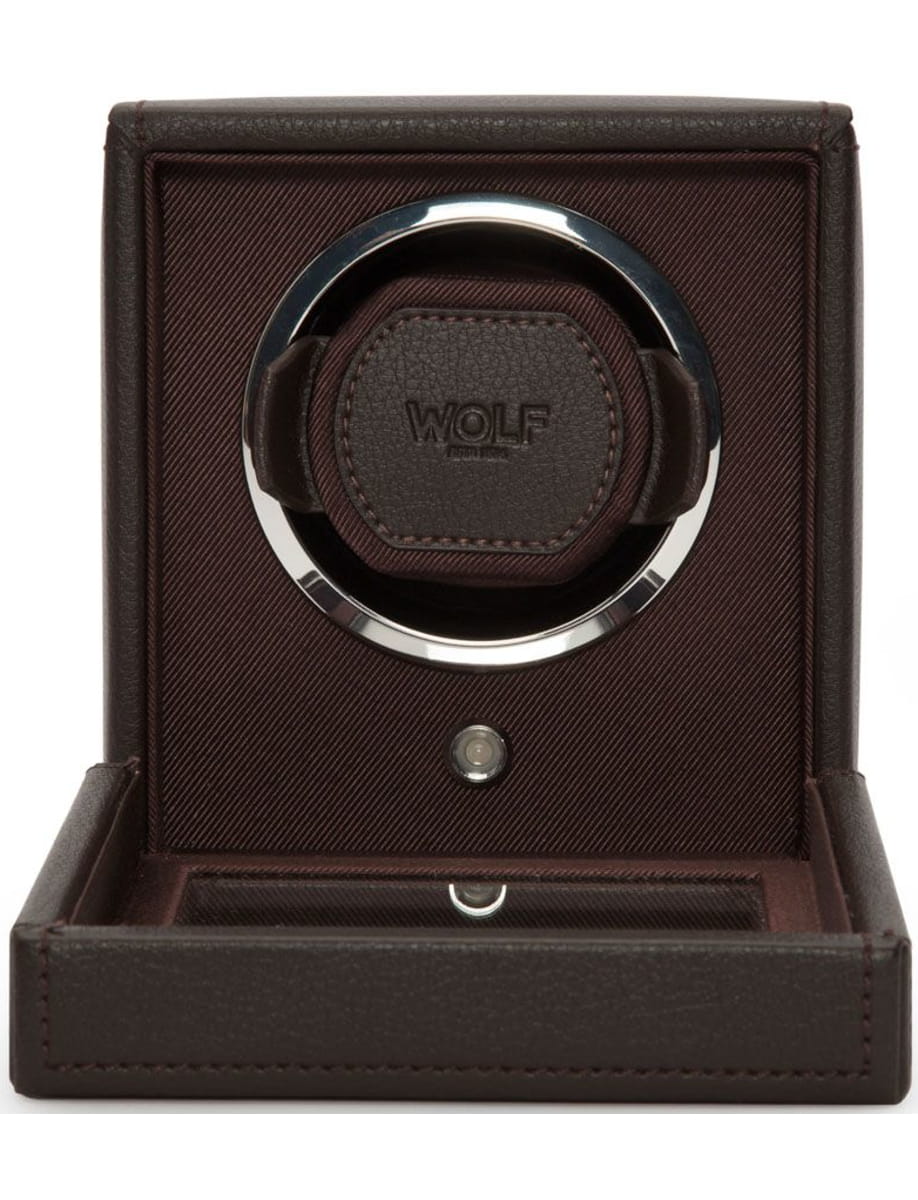 Brown leather jewelry display case open to reveal a dark brown ring mounted in a circular chrome holder