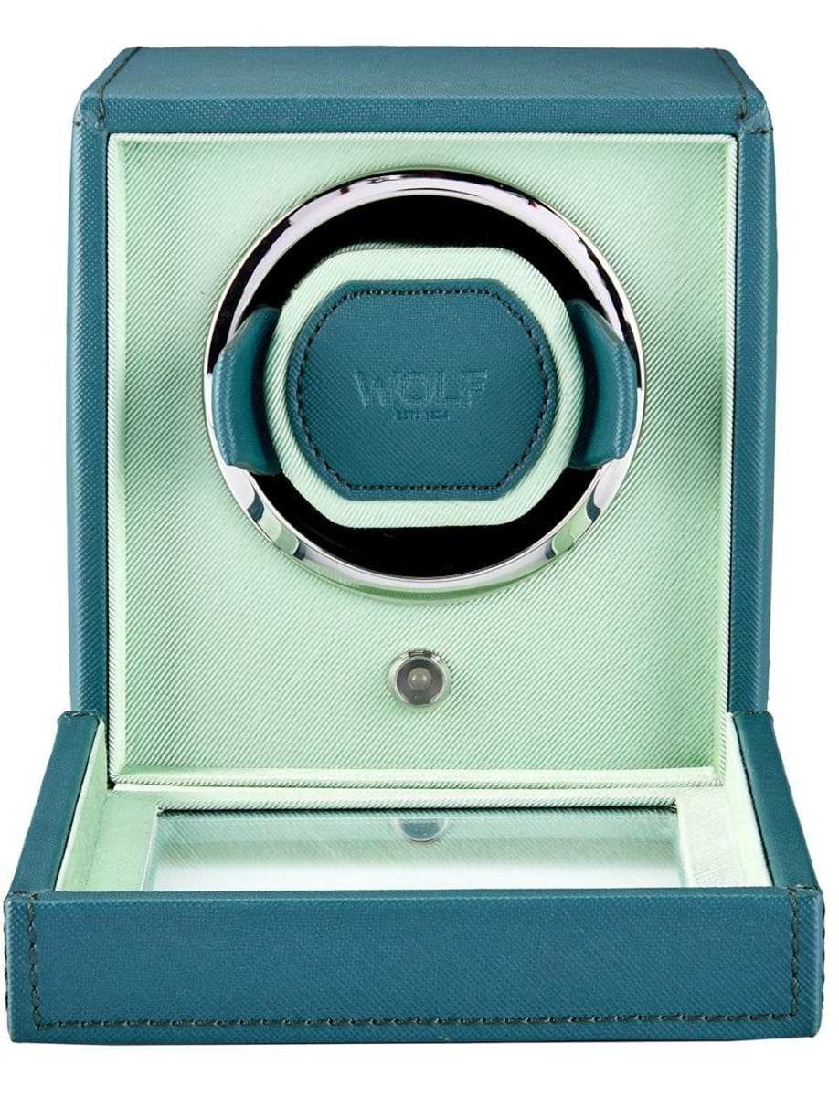Open teal leather jewelry box with a circular ring display resting on a mint interior lining.