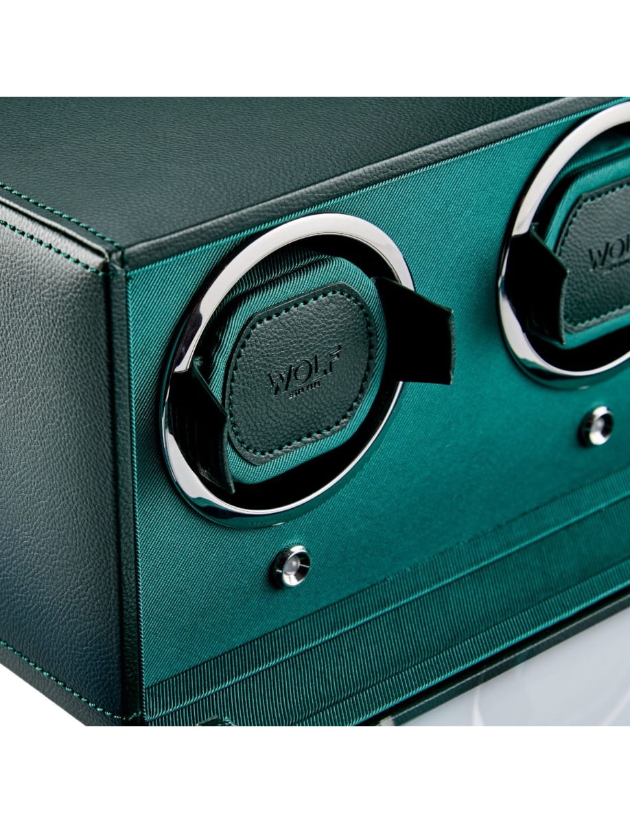 Teal and black luggage with two chrome ring latches and a WOLF logo patch in the center.