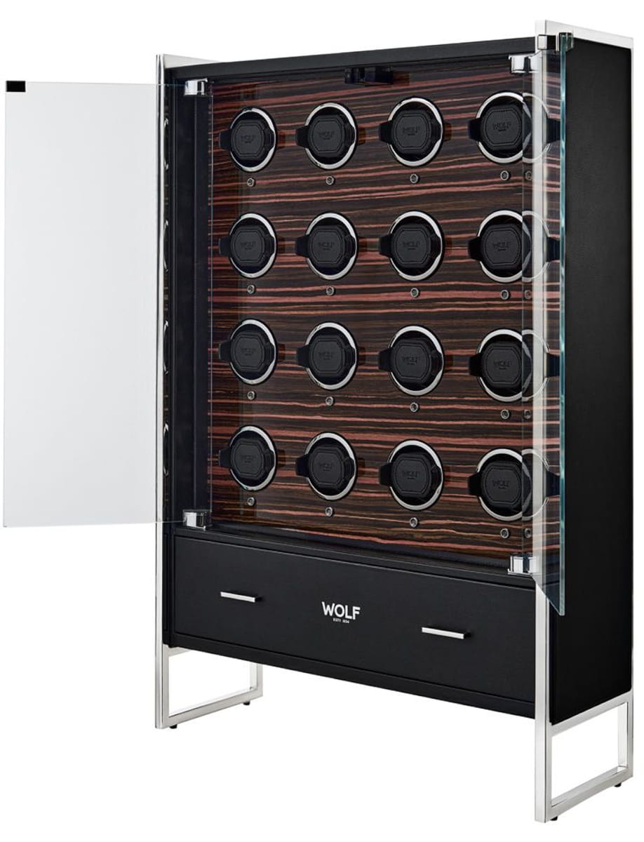 Tall black Wolf cabinet with glass front, showcasing 24 circular bottle slots on a wood veneer back panel; glass door open on the left, with two drawers at the base.