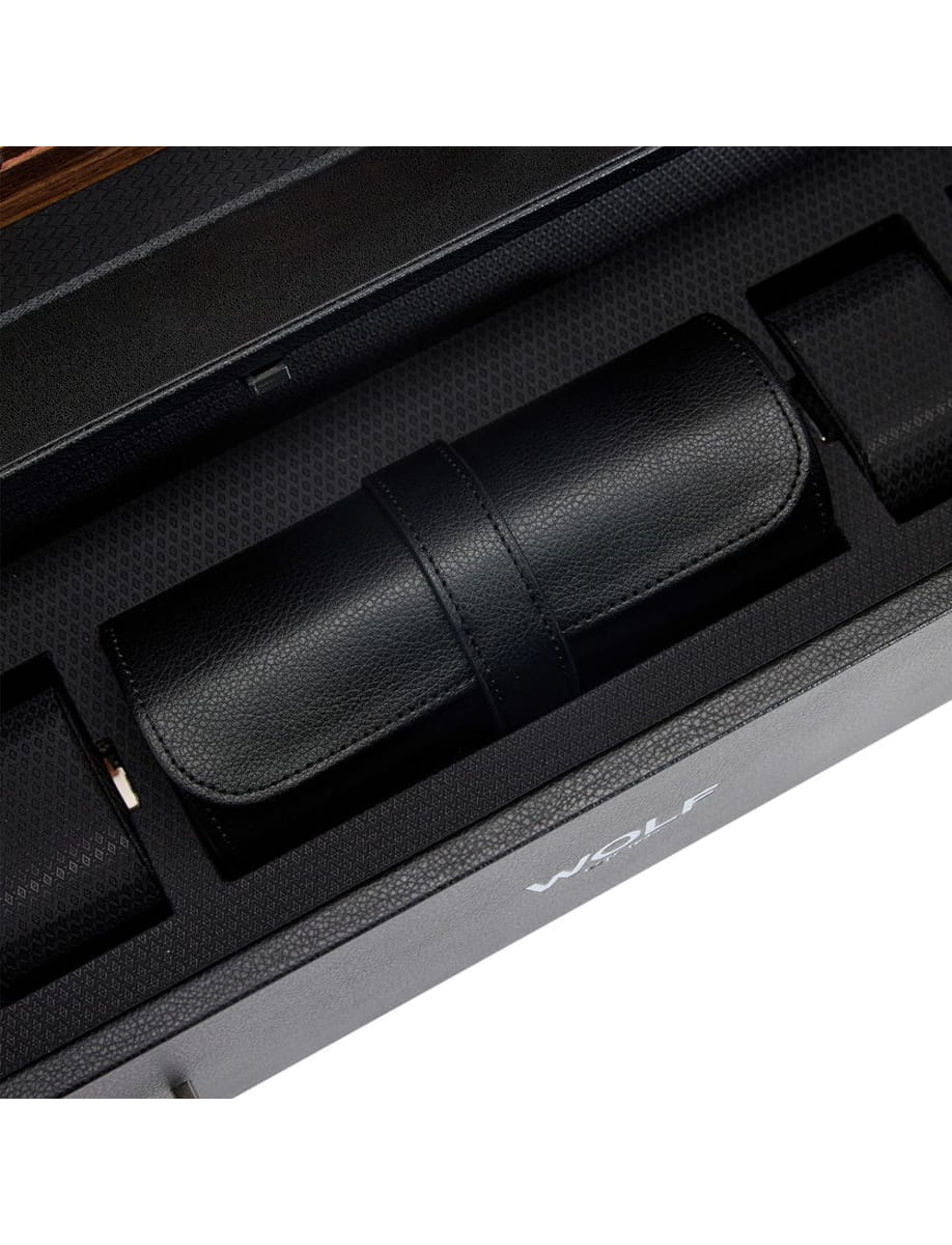 Close-up of a black leather travel roll with a strap, tucked inside a textured black Wolf presentation box.