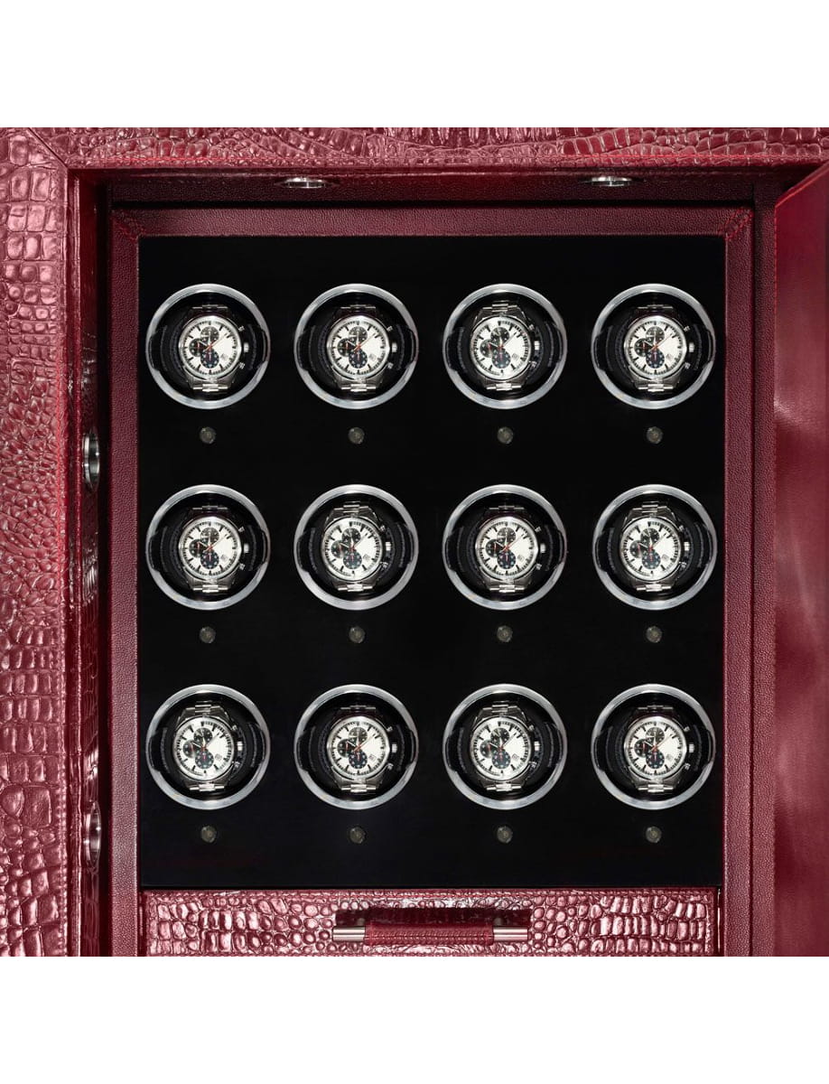 Open burgundy leather watch winder box showing twelve round watches neatly arranged in a 3x4 grid inside a black interior.