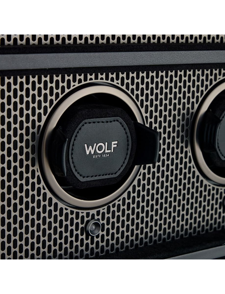 Close-up of a Wolf knob on a perforated metal grille, displaying 'WOLF EST 1834'.